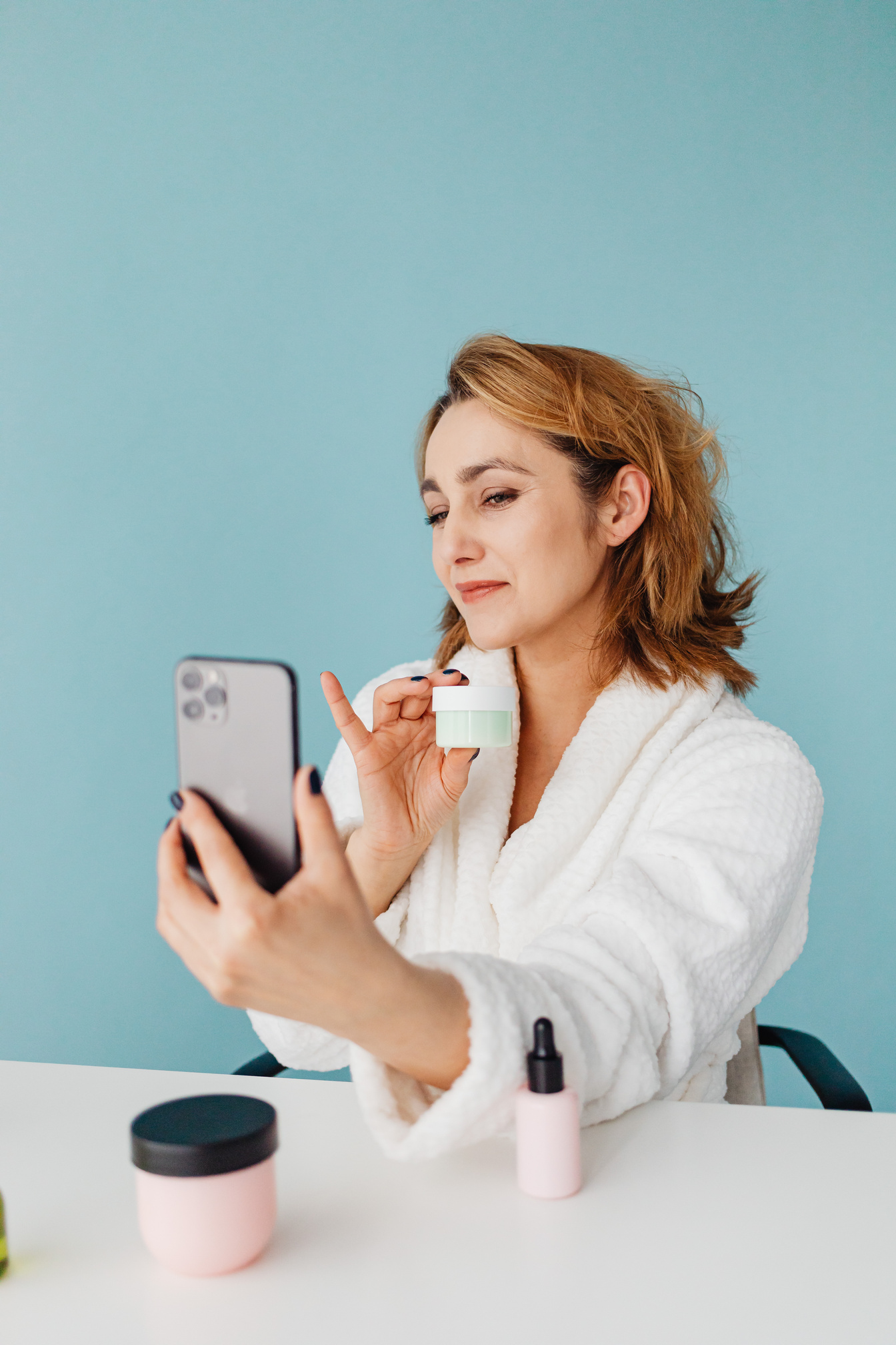 Woman Taking Photo with Cosmetic Product