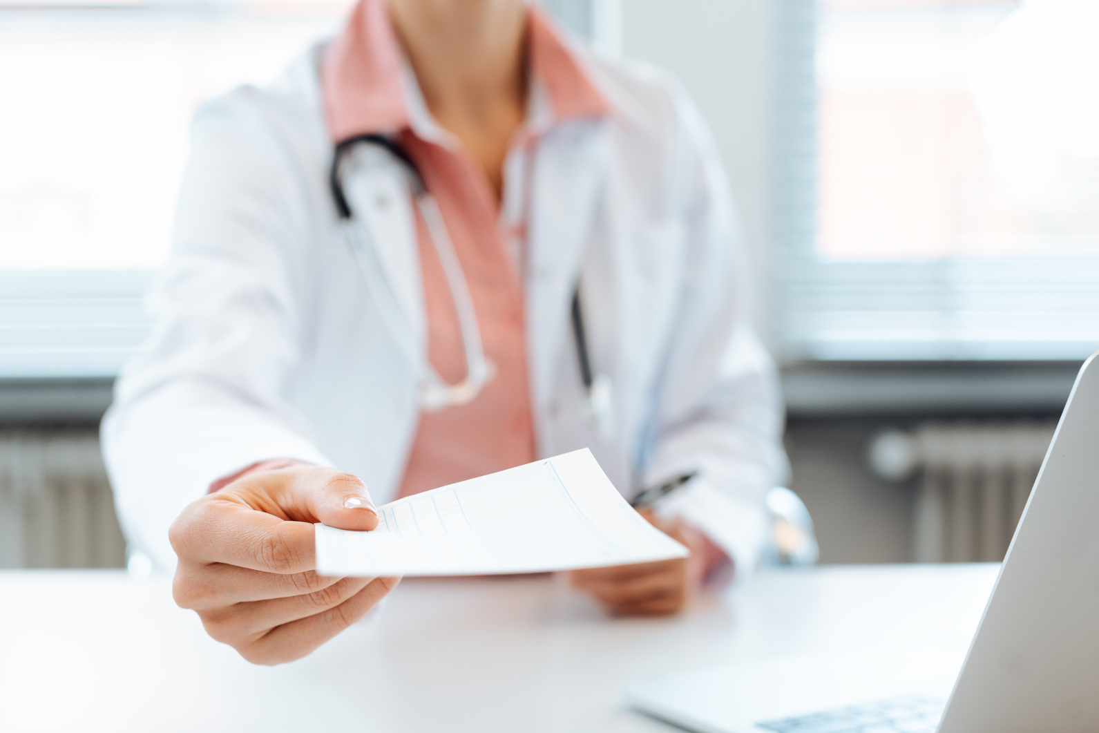 Doctor Holding Prescription Paper