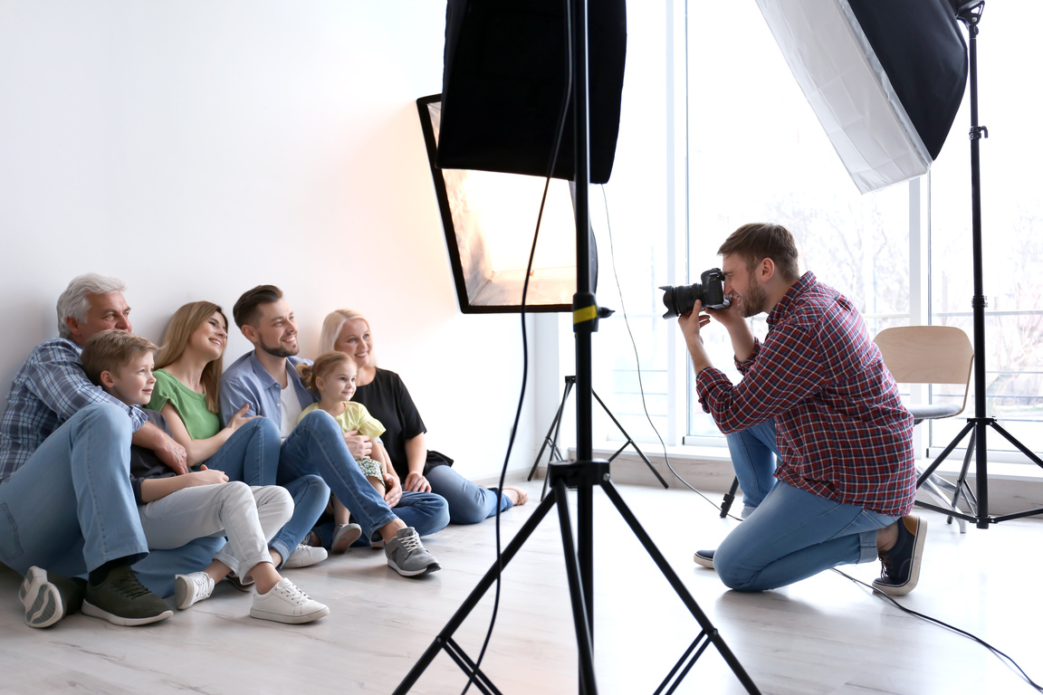 Professional Photographer Taking Photo of Family in Studio