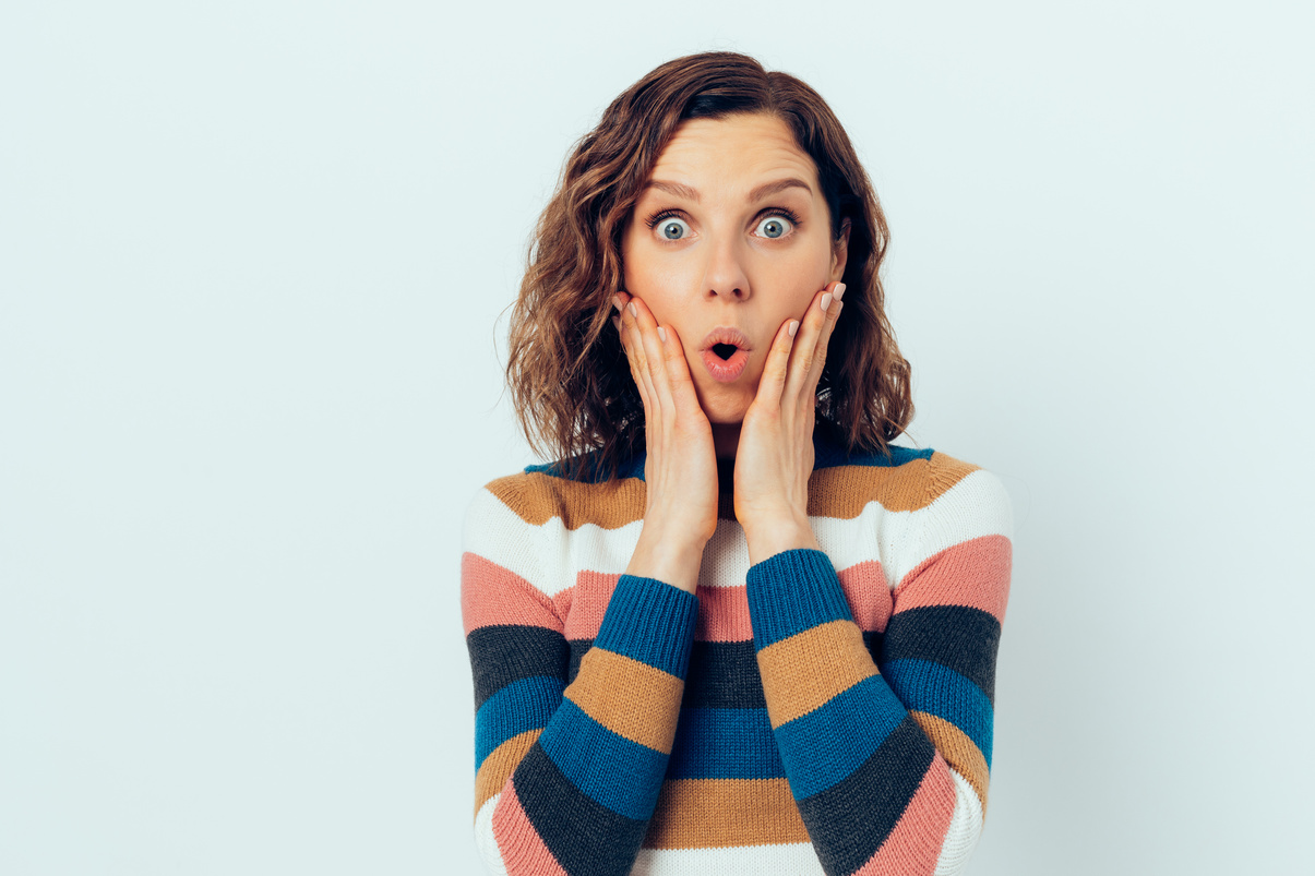 Surprised Woman Holding Hands on Face